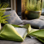 A patio with clean cushions arranged for outdoor seating.