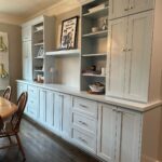 White built-in dining room cabinets with a long sideboard and upper open shelving.