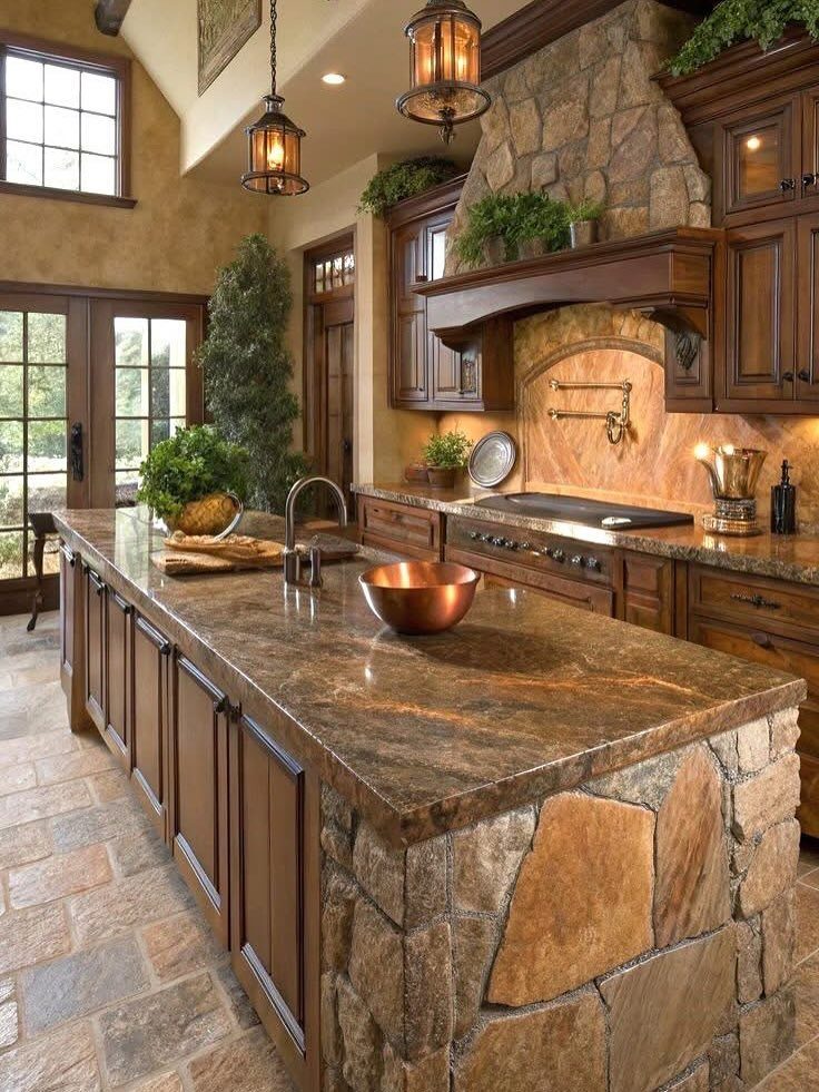 Rustic kitchen with granite island, stone accents, dark wood cabinets, and hanging lanterns.