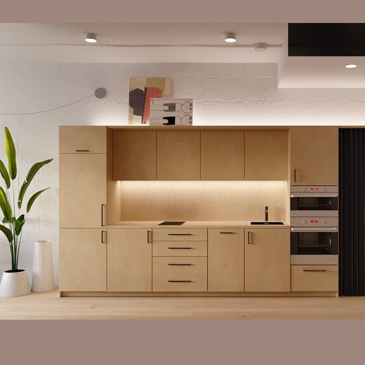 Modern one wall kitchen layout with light wood cabinets and built-in ovens.