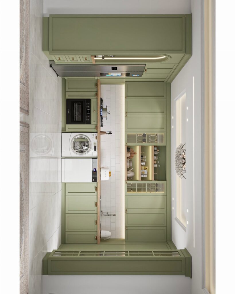 Sage green kitchen cabinets in a narrow room with white tiles and countertops.