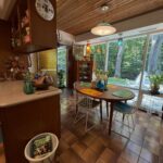 Vintage pendant light and colorful lamps in a mid-century modern kitchen dining area