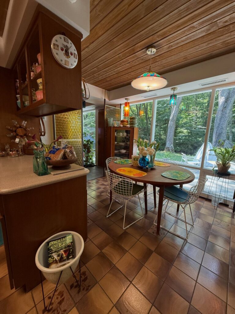 Vintage pendant light and colorful lamps in a mid-century modern kitchen dining area